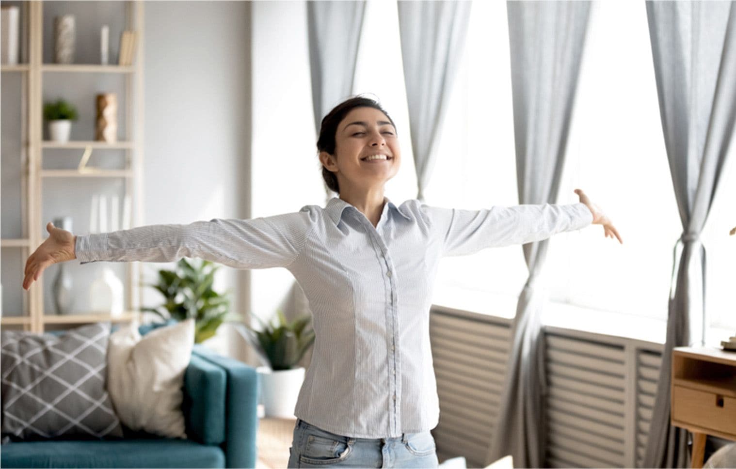 A woman incredibly happy with her living space because of clean and cool air by Carrier Philippines 