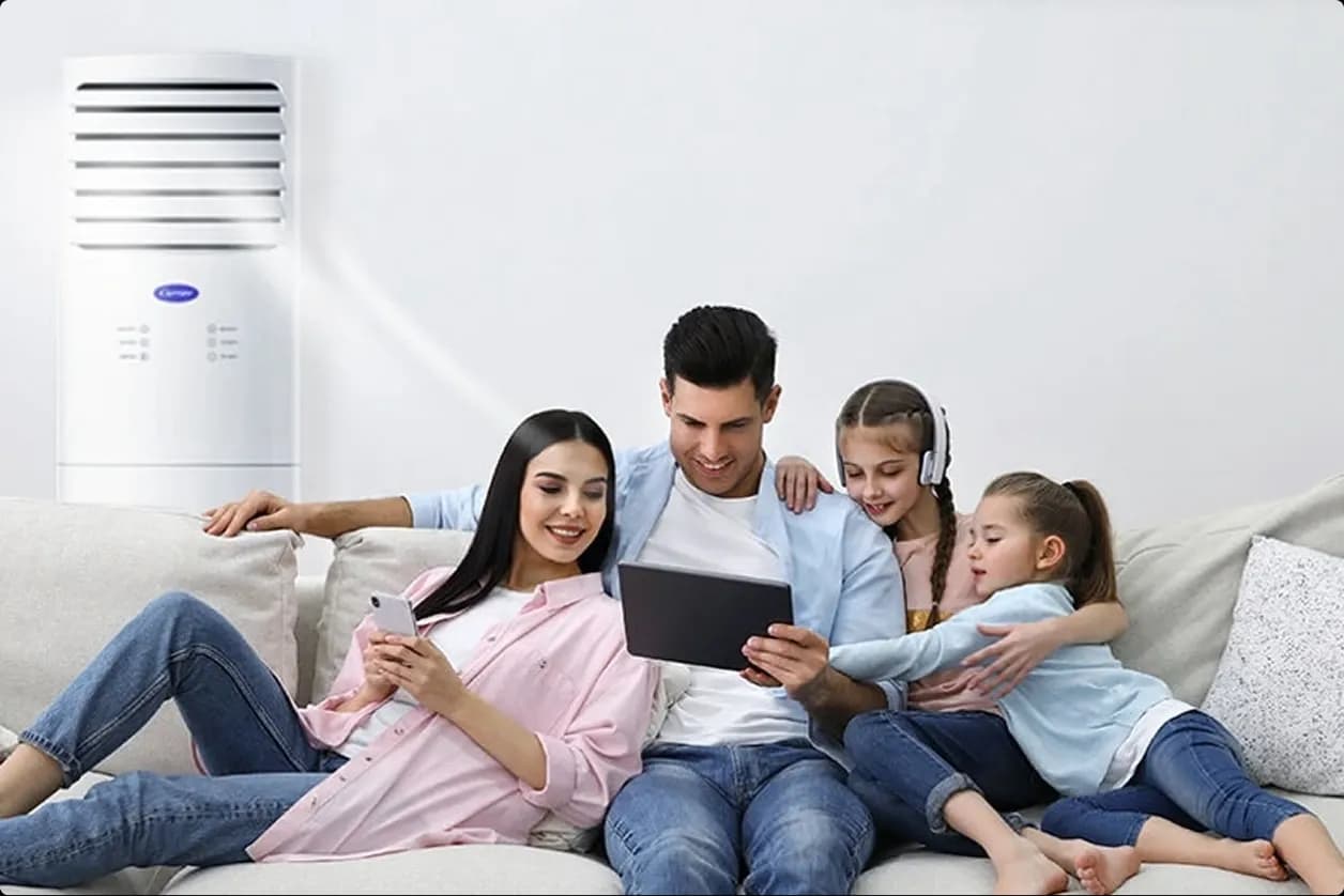A family of four comfortably bonding together in the living room thanks to floor mounted aircon cooling