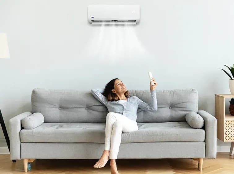 A woman enjoying her aircon because of clean air produced with the help of filters like silver ion filters