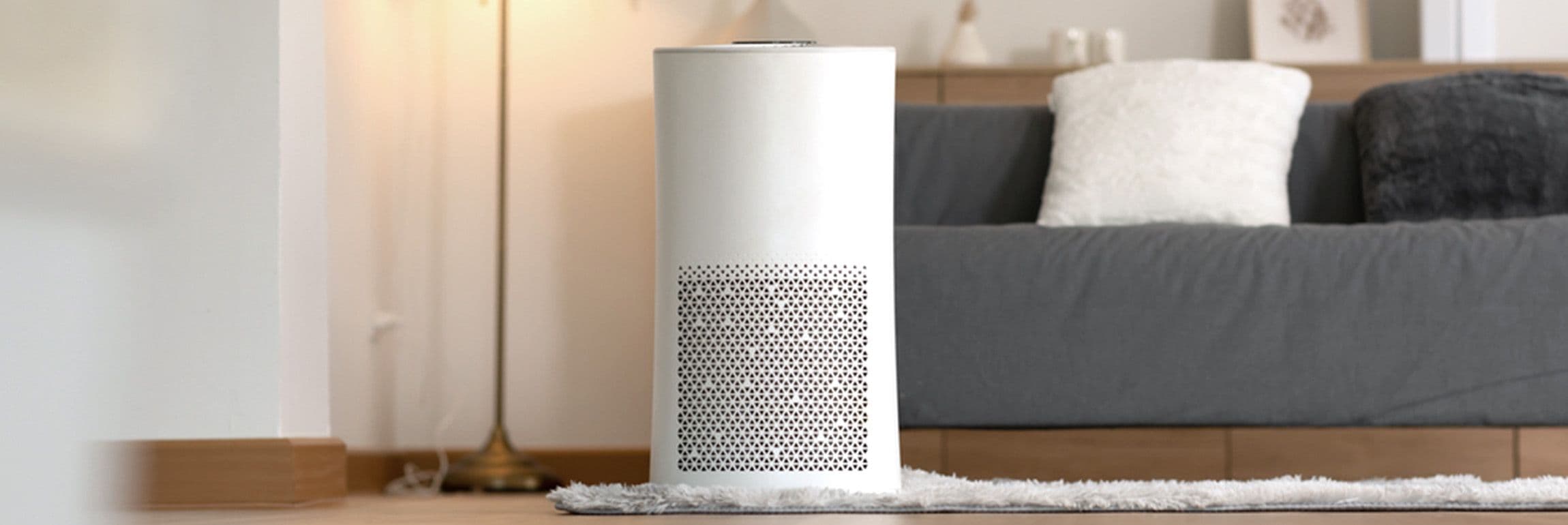 White air purifier placed in a bedroom and improving room air quality