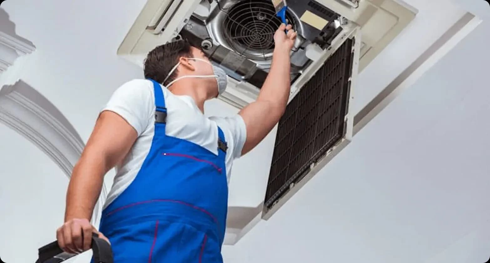 A maintenance expert checking a Carrier air conditioning unit and its performance