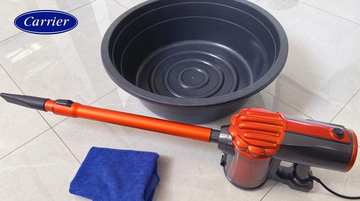 A medium sized basin and soft cloth and vacuum that will be used to clean an aircon