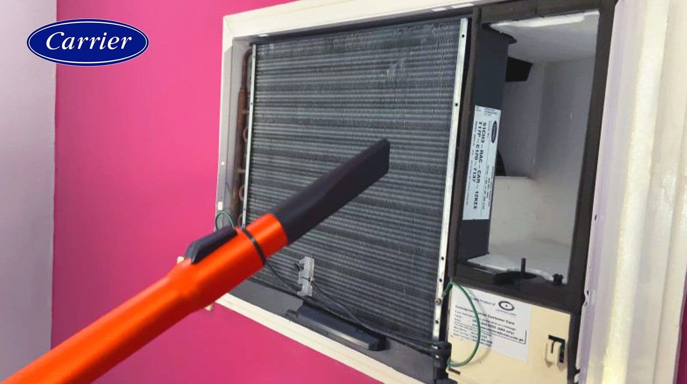 Cleaning the aircon fin with a vacuum cleaner where the vacuum tip is a few inches away from the fin