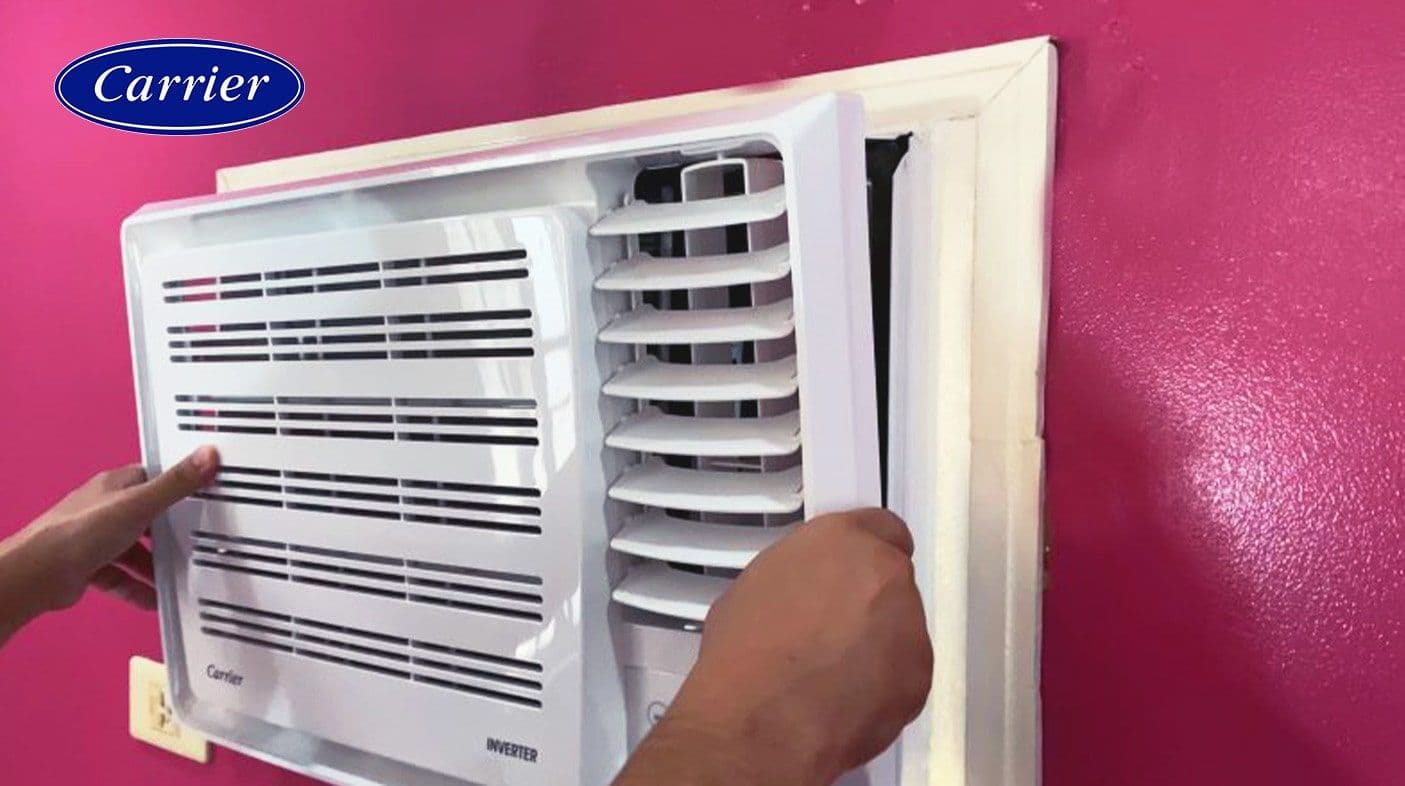 Gently attaching the front grille back on to the unit