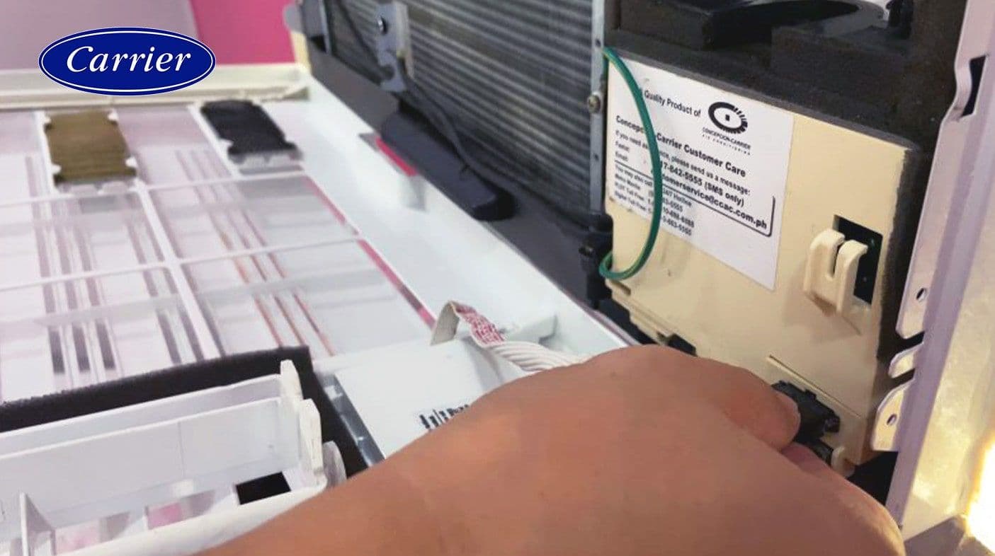 Pressing the connector to disconnect the wiring
