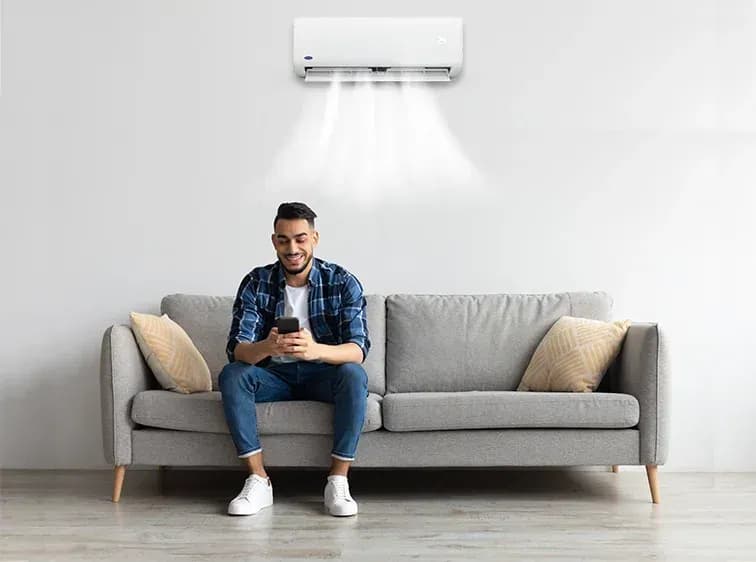A man who is happy to have maximized aircon energy savings through his Carrier aircon
